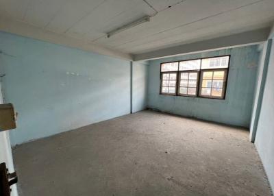 Spacious empty room with blue walls and large windows