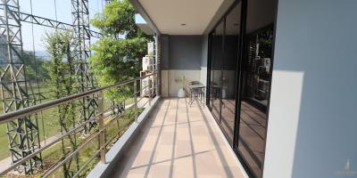 Spacious balcony with outdoor seating and garden view