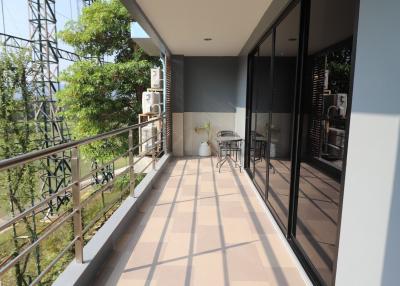 Spacious balcony with outdoor seating and garden view