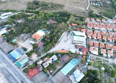 Aerial view of a residential area with diverse properties and surrounding landscape