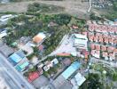 Aerial view of a residential area with diverse properties and surrounding landscape