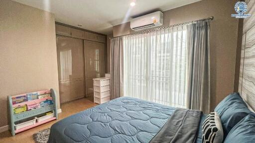 Cozy bedroom with a large bed, ample wardrobe, and air conditioning