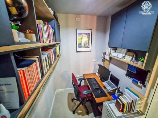 Compact home office with bookshelves and a computer setup