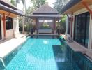 Private swimming pool with gazebo and tropical plants in a luxurious home