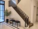 Elegant entryway with staircase, modern decor and natural lighting