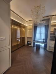 Elegant bedroom with chandelier and mirrored closet doors