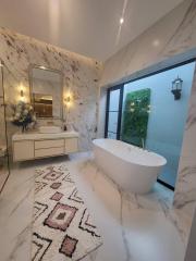 Elegant bathroom with a freestanding bathtub and marble finish