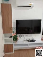 Modern living room interior with mounted television and air conditioning unit