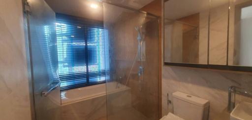 Modern bathroom interior with glass shower and large window