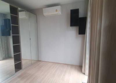Spacious bedroom with large window and air conditioning unit