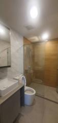 Modern bathroom with wooden cabinet and glass shower