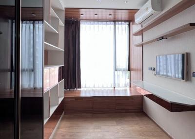 Modern bedroom with large window and reflective closet doors