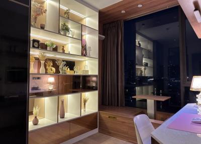 Elegant living room with shelf lighting and city view at night