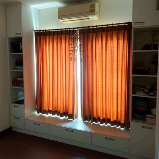 Cozy living room with bright natural light filtering through orange curtains