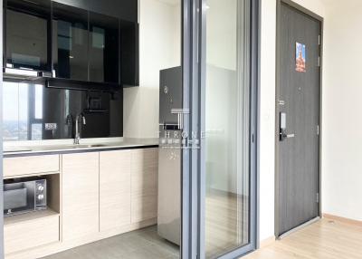 Modern kitchen with skyline view, equipped with built-in appliances