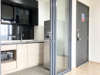 Modern kitchen with skyline view, equipped with built-in appliances