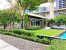 Lush greenery surrounding a pool in a residential apartment's common area with nearby public transport infrastructure