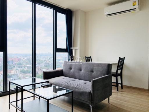 Spacious and modern living room with large windows and city view