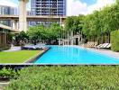 Luxury apartment complex with outdoor swimming pool and garden