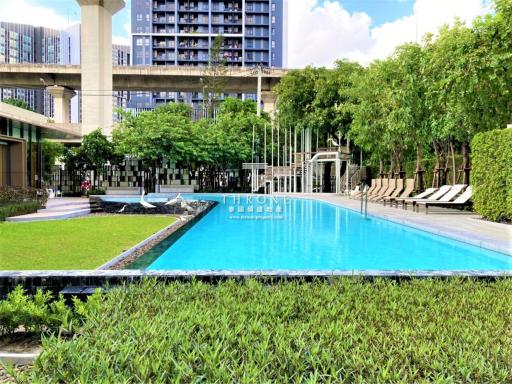 Luxury apartment complex with outdoor swimming pool and garden