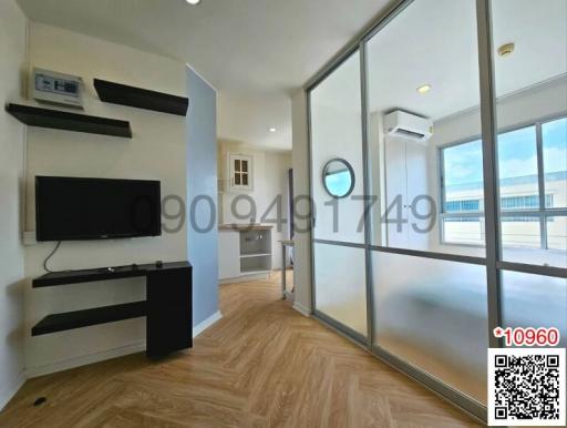 Modern bedroom with hardwood floors and large windows