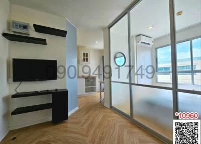 Modern bedroom with hardwood floors and large windows