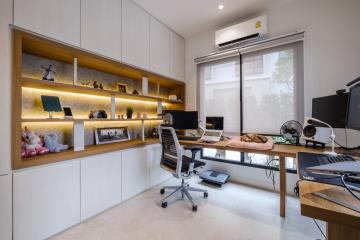 Modern home office with built-in shelving and desk space