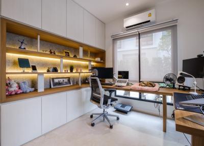 Modern home office with built-in shelving and desk space
