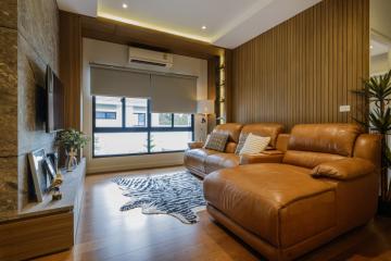 Modern living room with leather sofa and wooden accents