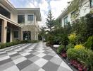 Elegant residential exterior with checkered pathway and green landscaping