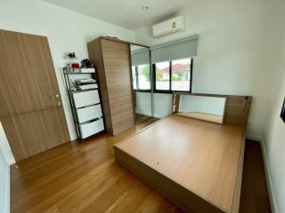 Spacious bedroom with large bed and mirrored wardrobe