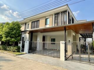 Modern two-storey residential home with a spacious front yard and gated entry