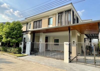Modern two-storey residential home with a spacious front yard and gated entry