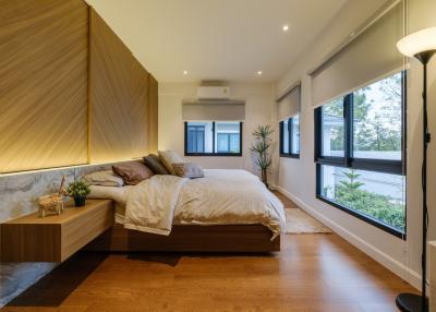 Modern bedroom with natural light and hardwood floors