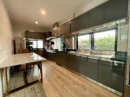 Modern kitchen with stainless steel appliances and marble countertop