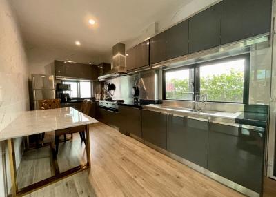 Modern kitchen with stainless steel appliances and marble countertop
