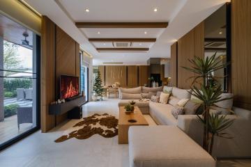Spacious living room with modern design, natural light, and a cozy fireplace