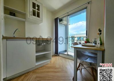 Compact apartment interior with kitchenette and balcony access