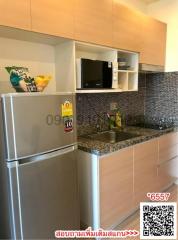 Compact kitchen with modern appliances and tiled splashback