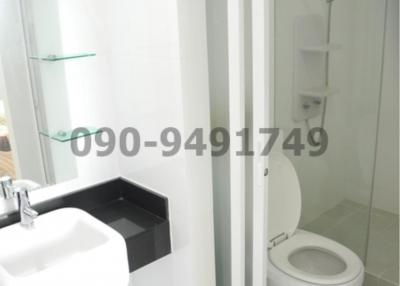 Modern white bathroom interior with glass shower cubicle