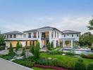 Luxurious two-story house with landscaped garden and swimming pool at twilight