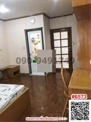 Cozy furnished living room with tiled floors and wooden accents