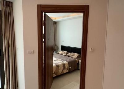 Modern bedroom viewed from the doorway featuring a neutral color palette