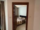 Modern bedroom viewed from the doorway featuring a neutral color palette