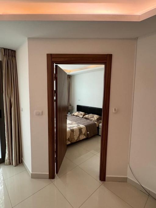 Modern bedroom viewed from the doorway featuring a neutral color palette