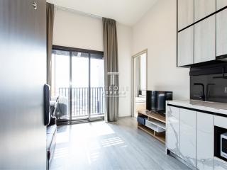 Bright and modern living room with open kitchen and balcony access