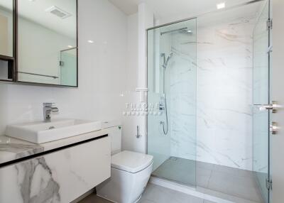 Modern bathroom with shower, toilet, and sink