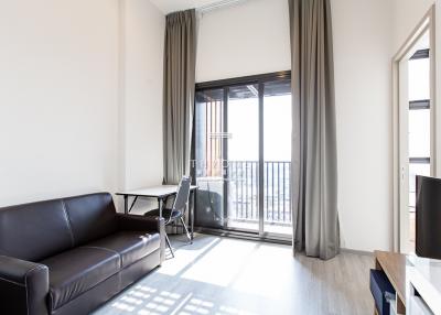 Modern living room with natural light and balcony access