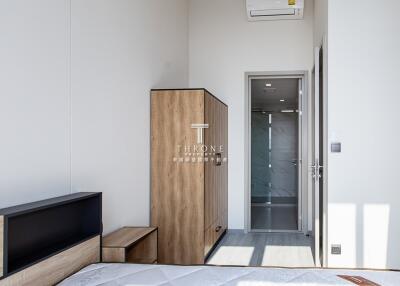 Modern bedroom with wardrobe, air conditioner, and ensuite bathroom