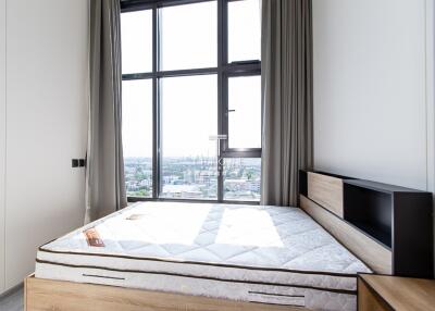 Modern bedroom with large windows and a bed